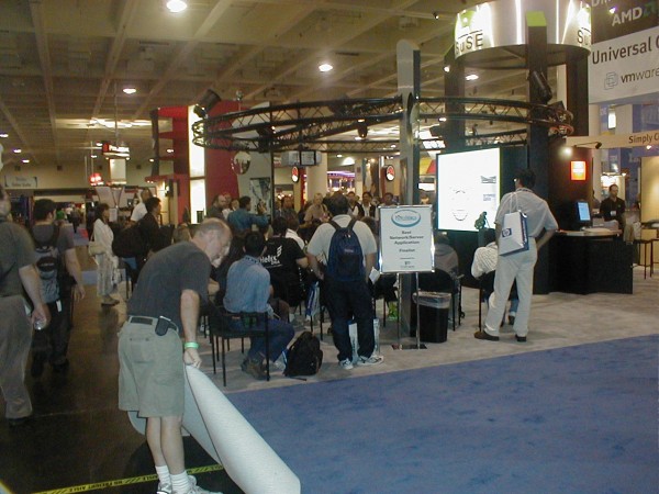 trade Show Booth - Crowd Watching Presentation While Carpets Being Rolled-up